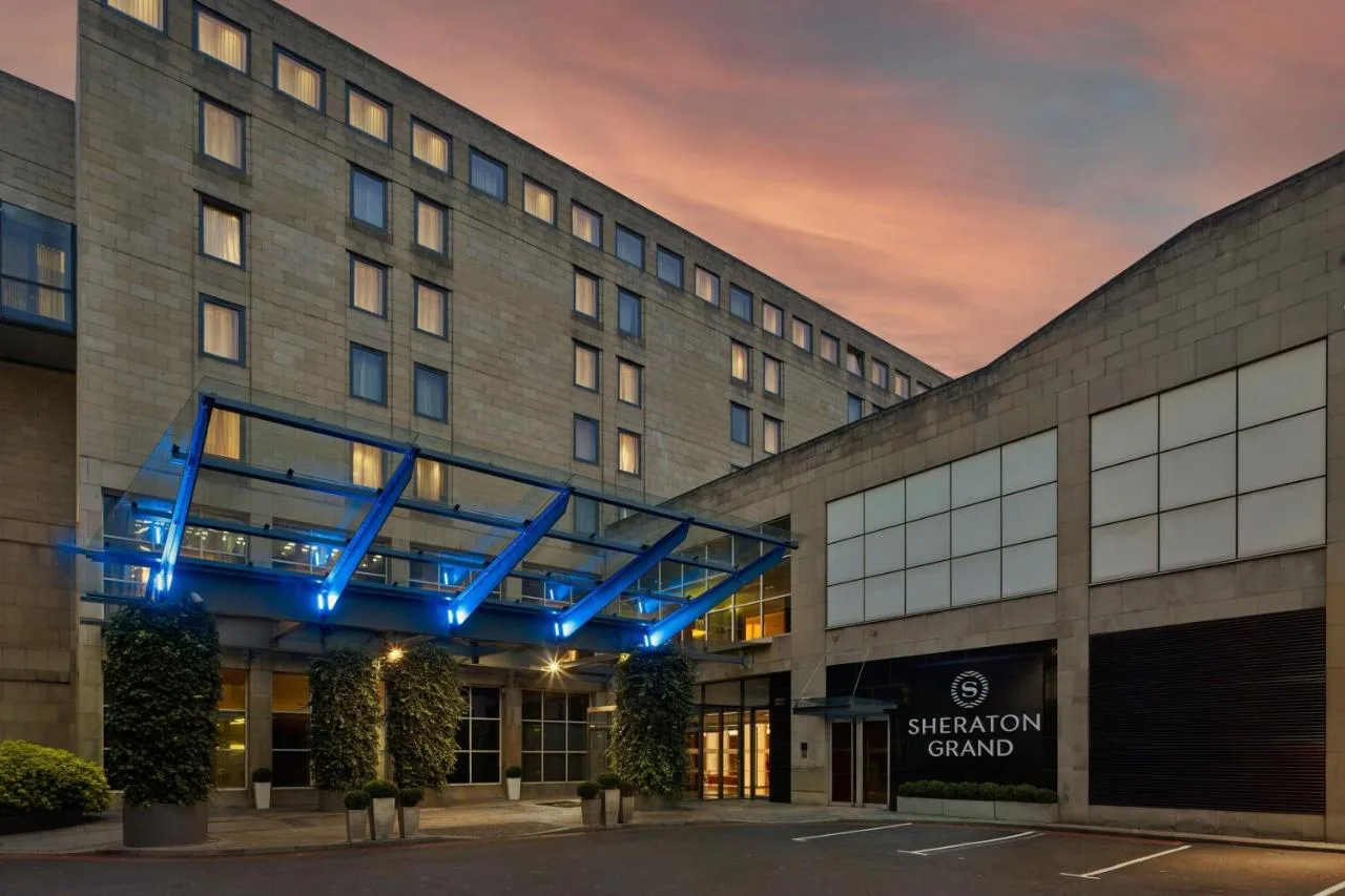 Sheraton Grand Hotel & Spa exterior lit up at night in Edinburgh's Festival Square