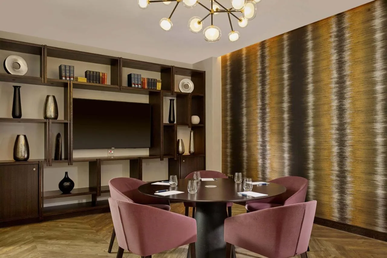 Dining table and chairs with television at Sheraton Grand Hotel & Spa, Edinburgh